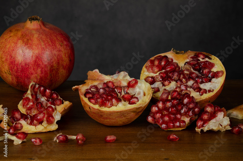 Still life of pomegranate fruits against gray wall