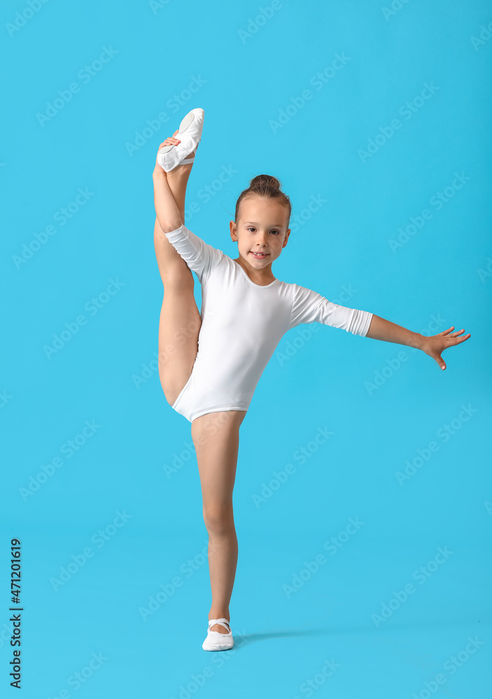 Foto de Little girl doing gymnastics on color background do Stock