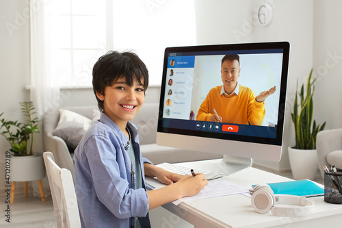Little boy studying online at home