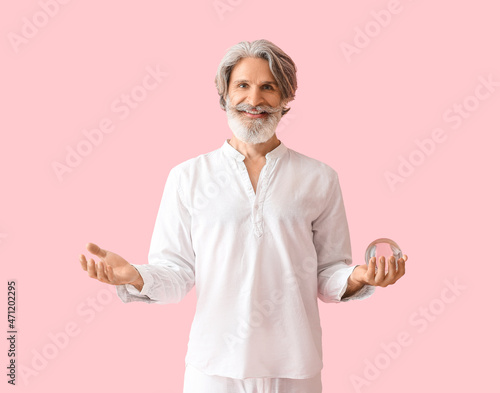 Mature man with crystal bal...
