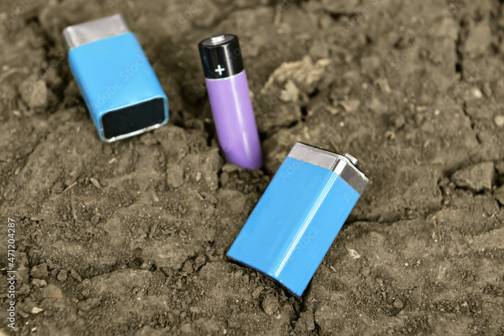 Alkaline batteries on soil outdoors Alkaline batteries on soil outdoors