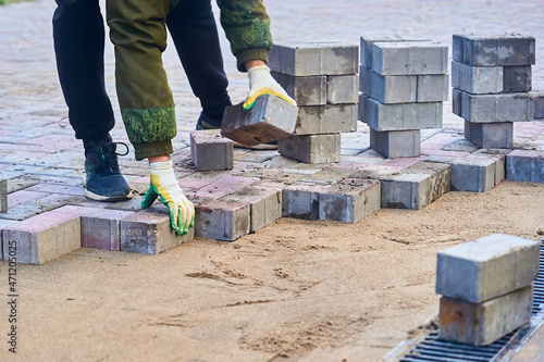 laying paving slabs on the sand with your hands