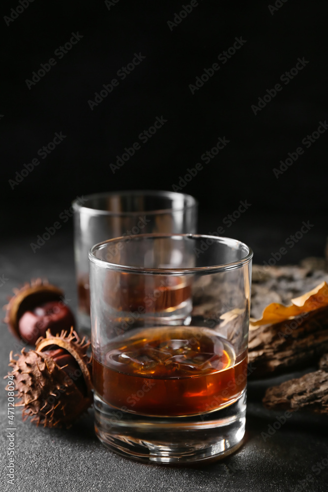 Glasses of cold chestnut whiskey on black background Glasses of cold chestnut whiskey on black background