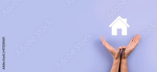 Real estate concept, businessman holding a house icon.House on Hand.Property insurance and security concept. Protecting gesture of man and symbol of house