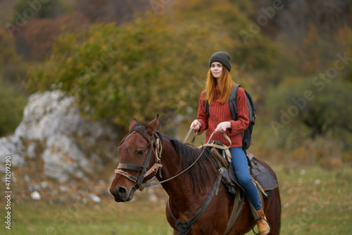woman hiker riding a horse on nature travel © SHOTPRIME STUDIO