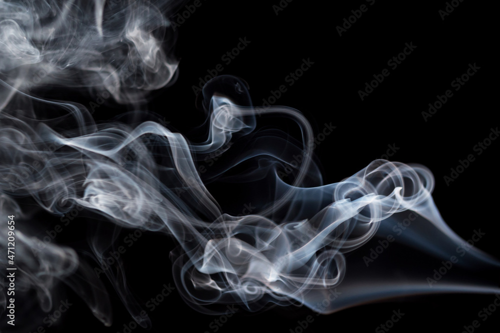Abstract background of chaotically mixing puffs of smoke on dark background. Concept of alternative non-nicotine smoking. Color smoke on dark background. E-cigarette. Blurry image, soft focus. Vaping Abstract background of chaotically mixing puffs of smoke on dark background. Concept of alternative non-nicotine smoking. Color smoke on dark background. E-cigarette. Blurry image, soft focus. Vaping