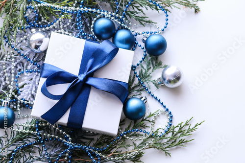 christmas background. frame made of fir branches and blue Christmas tree decorations. garlands and tinsel 