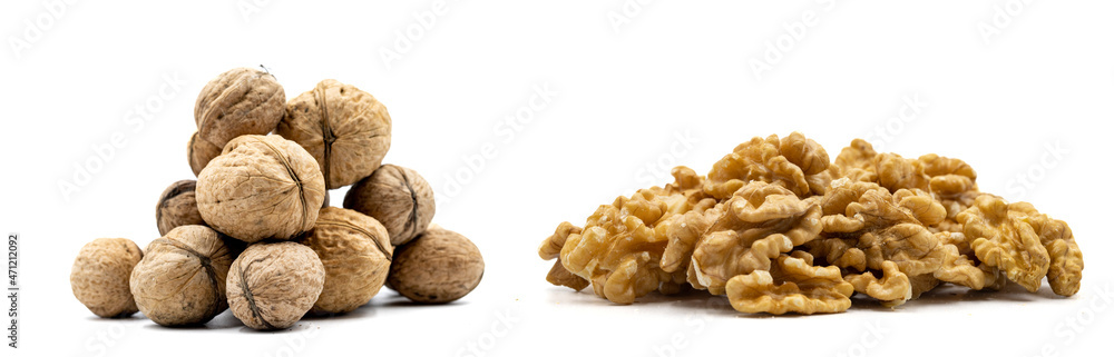 Shelled walnuts and walnut kernels isolated on a white background. close-up nuts Shelled walnuts and walnut kernels isolated on a white background. close-up nuts