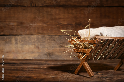 Fotografie, Obraz Manger with baby on wooden background. Concept of Christmas story
