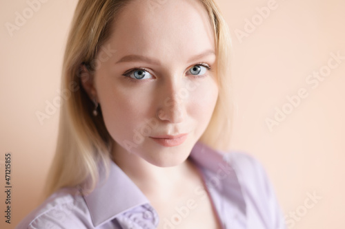 Portrait of a beautiful young woman with blue eyes.