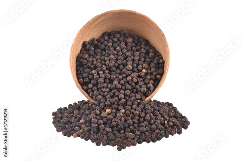 Black pepper peppercorns in wooden bowl isolated on white background.