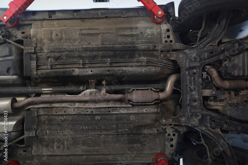 Car lifted in maintenance service to check availability undercarriage of automobile