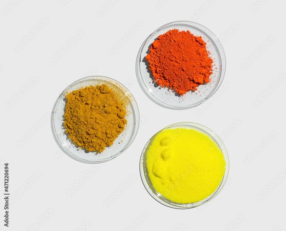 Lead (II,IV) oxide, Potassium Chromate and Organic Curcuma Powder in Chemical Watch Glass. Closeup chemical ingredient on white laboratory table. Top View Lead (II,IV) oxide, Potassium Chromate and Organic Curcuma Powder in Chemical Watch Glass. Closeup chemical ingredient on white laboratory table. Top View