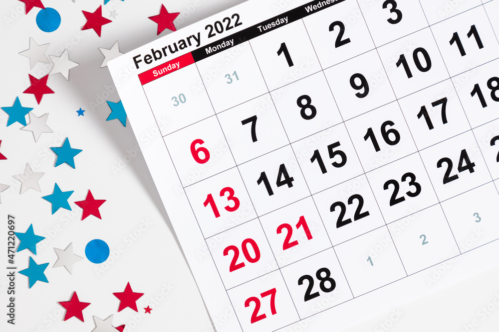 Presidents Day. Date on calendar February 21, 2022. Red, blue and white star confetti, decorations on white background. Flat lay, top view, copy space Presidents Day. Date on calendar February 21, 2022. Red, blue and white star confetti, decorations on white background. Flat lay, top view, copy space