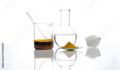 Photography Ferric Chloride Liquid with stirring rod in Beaker, Crystal clear liquid in Flat Bottom Flask, Organic Curcuma Powder and White flake chemical