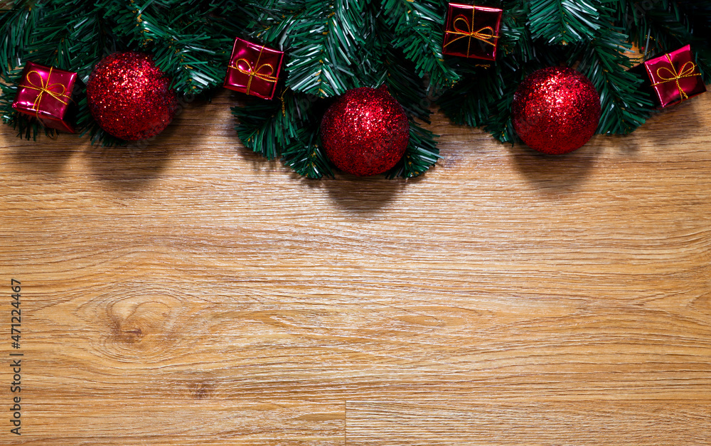 Christmas and Holiday background with fir tree and red christmas decorations on wood background Christmas and Holiday background with fir tree and red christmas decorations on wood background