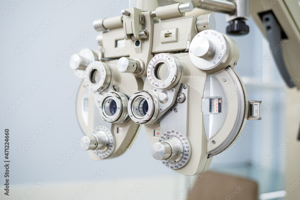 Microscopic apparatus for testing eyesight. Ophthalmology and treatment of eye diseases. Eye clinic, optometrist concept Microscopic apparatus for testing eyesight. Ophthalmology and treatment of eye diseases. Eye clinic, optometrist concept