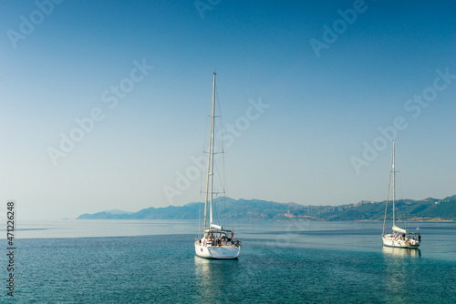 boats sway on the turquoise waves of the Ionian sea of Greece in sunny weather