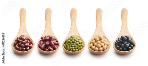 Wooden spoon filled with various type of beans over white background