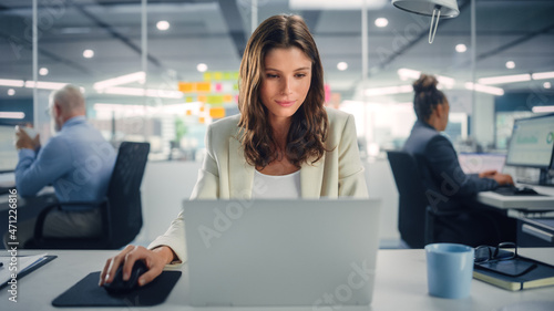 Young Happy Businesswoman Using Computer in Modern Office with Colleagues. Stylish Beautiful Manager Smiling, Working on Commercial, Financial and Marketing Projects. Specialist in Diverse Team.