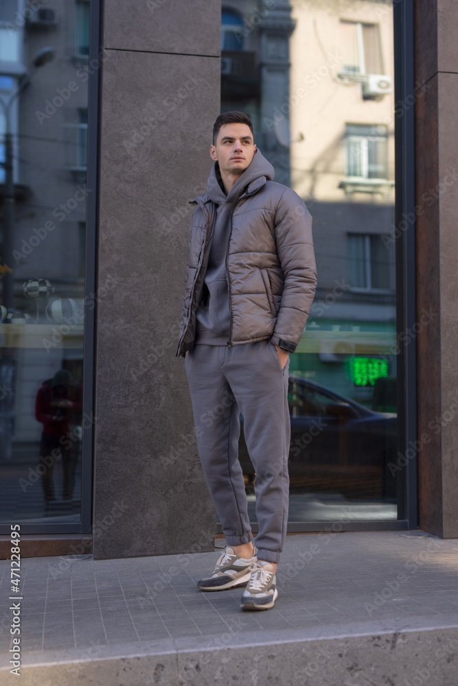 Man posing in city wearing winter jacket
