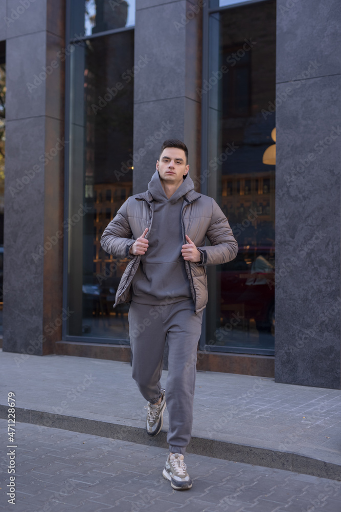 Man walking in city wearing winter jacket Man walking in city wearing winter jacket