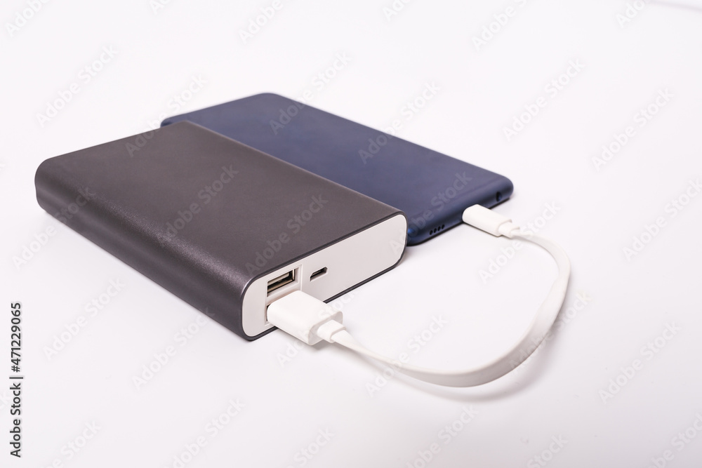 Smartphone is charging from the power bank. Smartphone is charging from the power bank.