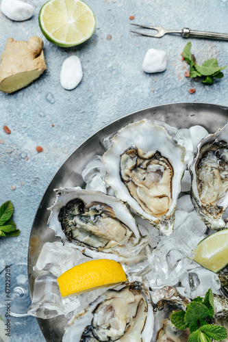 Fresh oysters with lemon and ice. Restaurant delicacy. oysters dish. Oyster dinner with champagne in restaurant