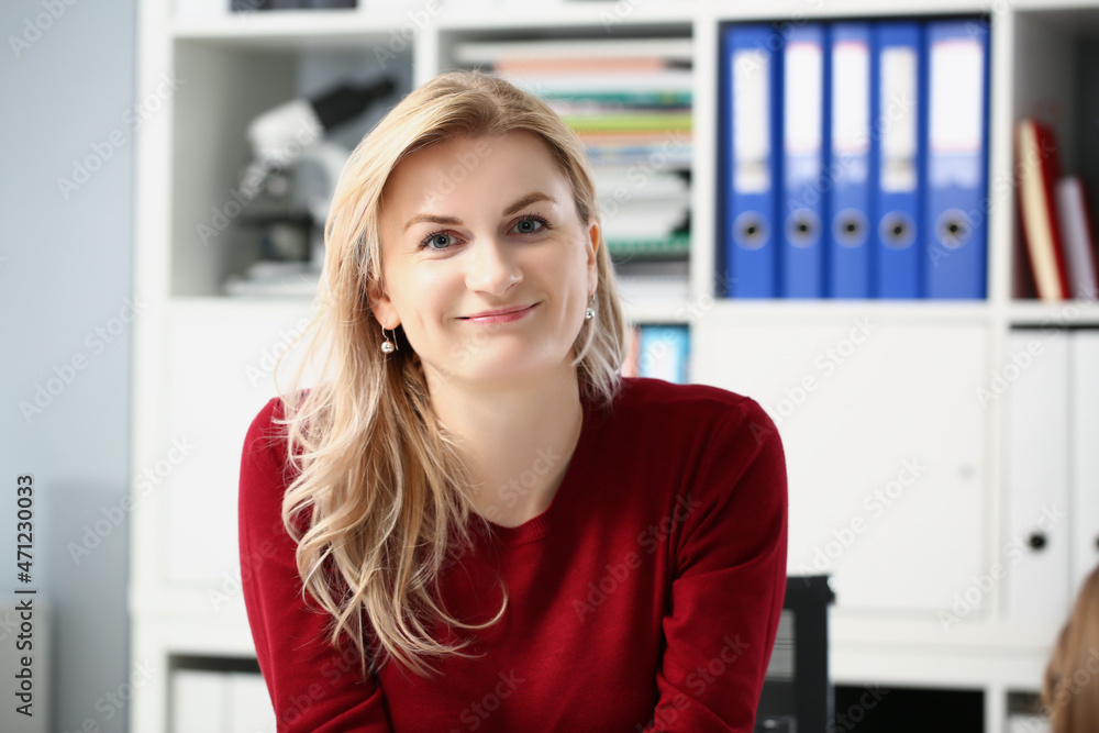 Fototapeta premium Beautiful young woman office worker posing in personal cabinet