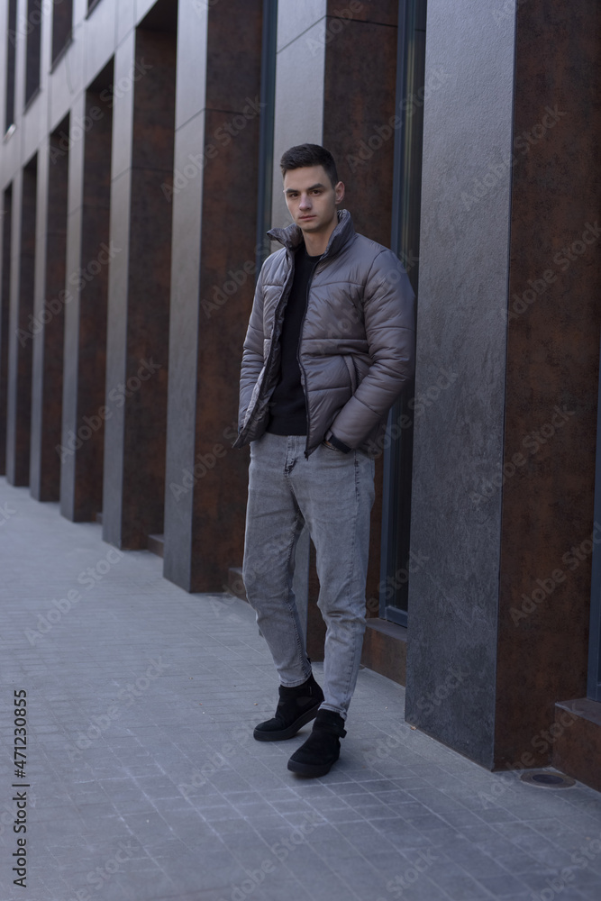 Man posing in city wearing winter jacket Man posing in city wearing winter jacket
