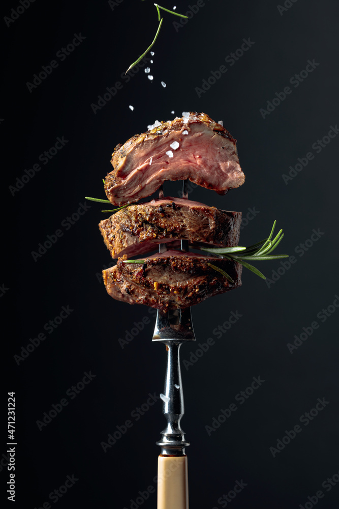 Ταπετσαρία Grilled ribeye beef steak with rosemary on a black background.