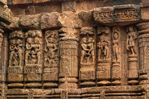 Temple platform of Jagamohana carved with  erotic couples, young women flaunting their beauty in poses, nagas, vyalas, soldiers, elephants, court scenes Sun Temple Konark, Odisha, India. photo