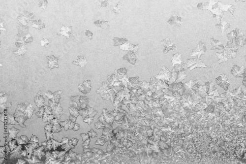 Frost on the window, Natural texture on glass with frozen pattern. Copy space, natural background, macro. Beautiful winter background