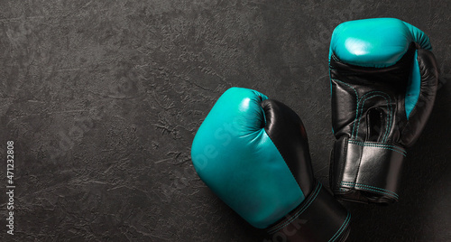 Green boxing gloves on a black background. Template Copy space for text. mock-up