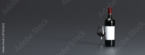 bottle of wine and glass of wine on gray background