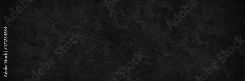Black white grunge background. Dark concrete wall. Cement surface texture. Rough background with copy space for design. Wide banner. Panoramic.