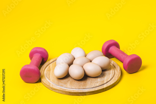Eggs and a dumbbells, protein for athletes