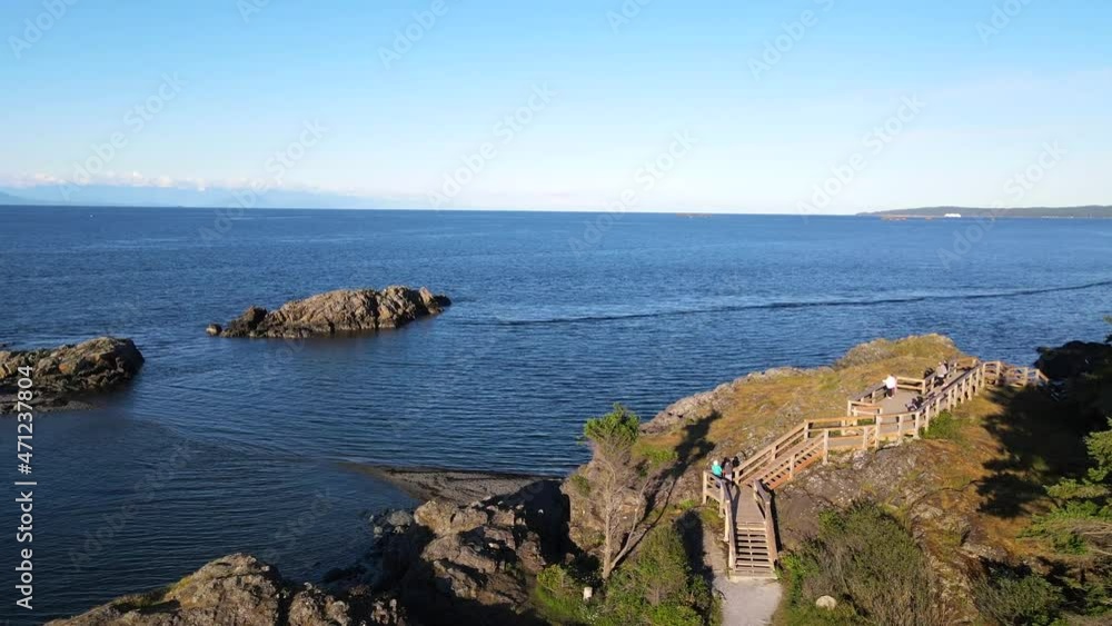 Aerial view of Neck Point Park in Nanaimo. Drone flying above quickly in a curve above people, bluffs and trails while heading towards open water. Canadian parks captured from above and in ultra HD. Aerial view of Neck Point Park in Nanaimo. Drone flying above quickly in a curve above people, bluffs and trails while heading towards open water. Canadian parks captured from above and in ultra HD.