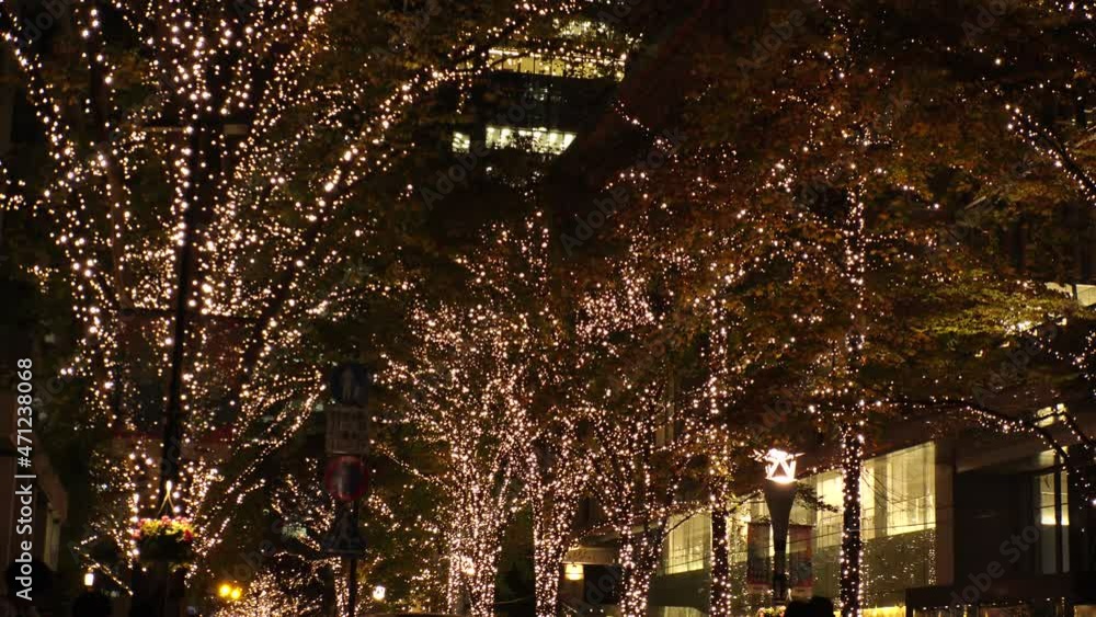 TOKYO, JAPAN - NOVEMBER 2021 : Christmas illumination, led light up at Marunouchi area. Scenery of downtown city and street at night. Japanese winter and Christmas season concept. TOKYO, JAPAN - NOVEMBER 2021 : Christmas illumination, led light up at Marunouchi area. Scenery of downtown city and street at night. Japanese winter and Christmas season concept.