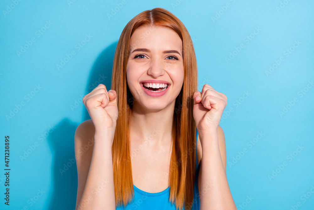 Photo portrait red haired woman wearing casual outfit gesturing like winner isolated pastel blue color background