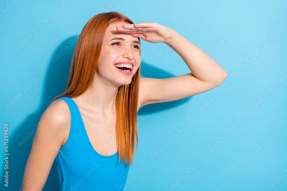 Photo portrait red haired woman laughing looking far hand near forehead isolated pastel blue color background