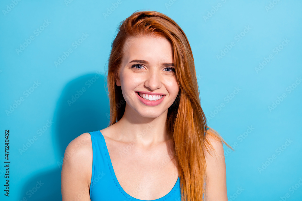 Portrait of nice attractive cheerful girl shine red hair isolated over bright blue color background Portrait of nice attractive cheerful girl shine red hair isolated over bright blue color background