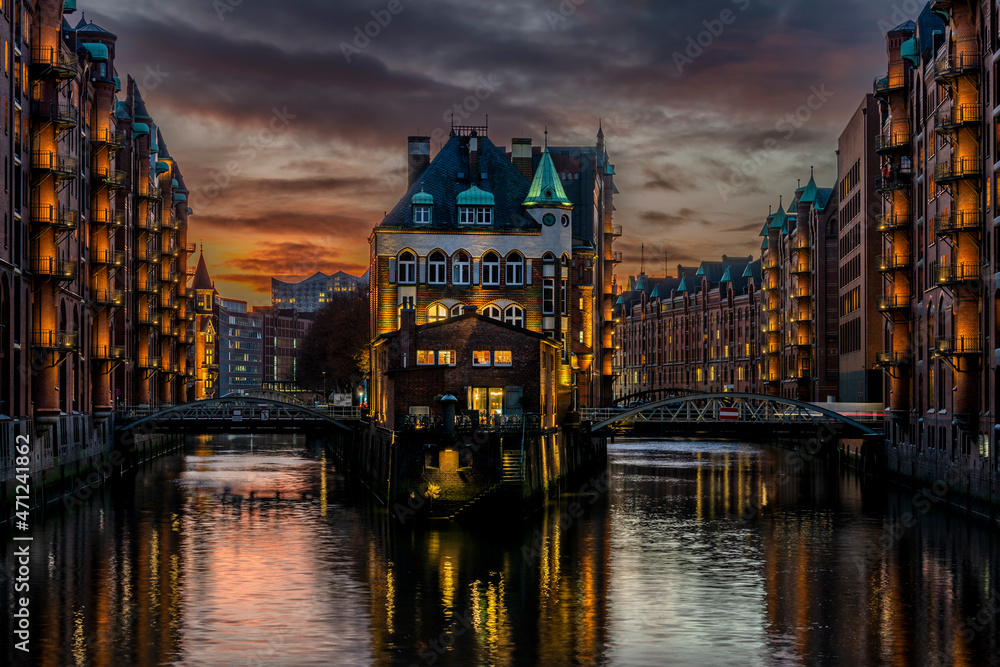 High dynamic and detailed photography of the illuminated Speicherstadt with the Wasserschloss in Hamburg at sunset