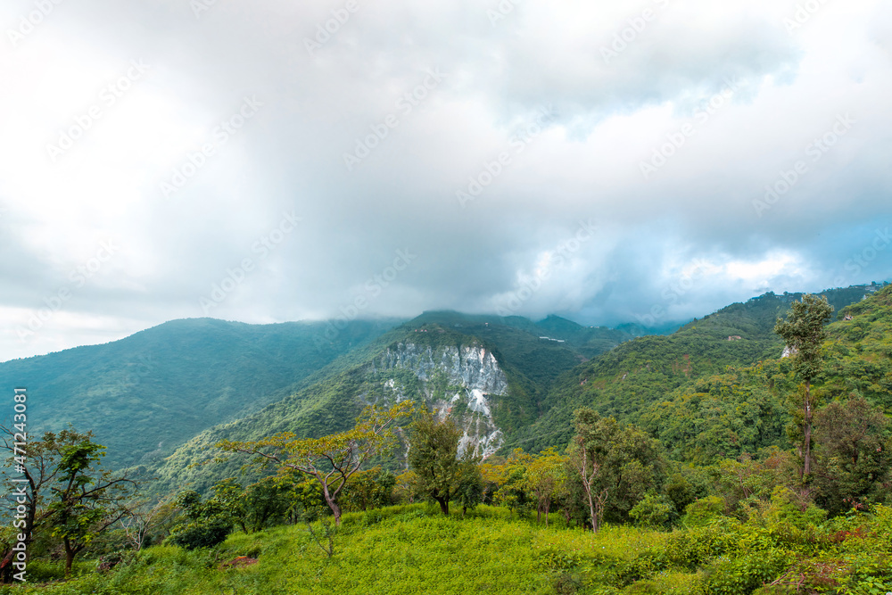 Panoramic view of mountains under cloudy sky in Uttarakhand