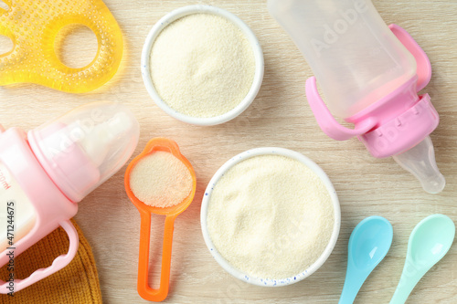 Concept of baby food with рowdered milk on wooden background