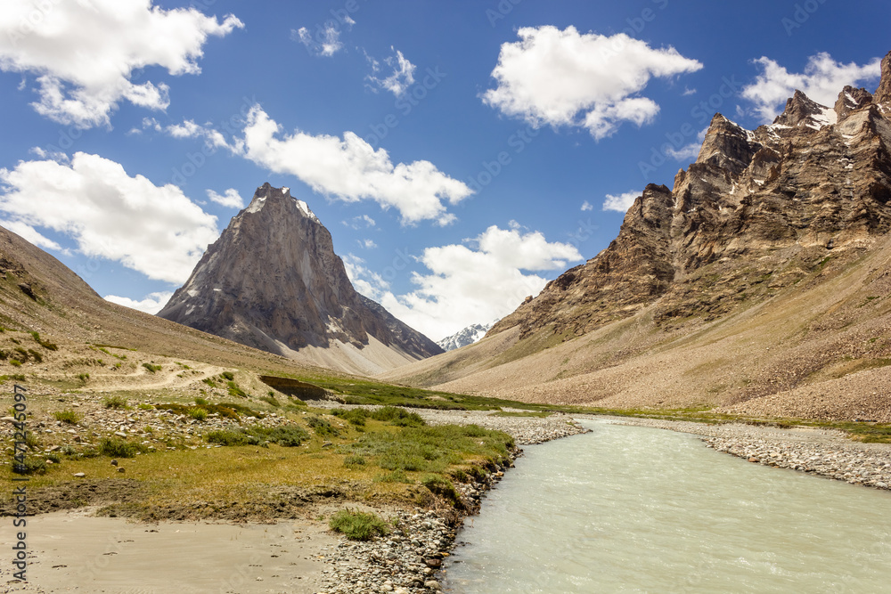 The Kargyak river with the granite mountain peak of Mount Gumbok Rangjon on the Darcha Padum trekking route in the Zanskar valley in Ladakh..