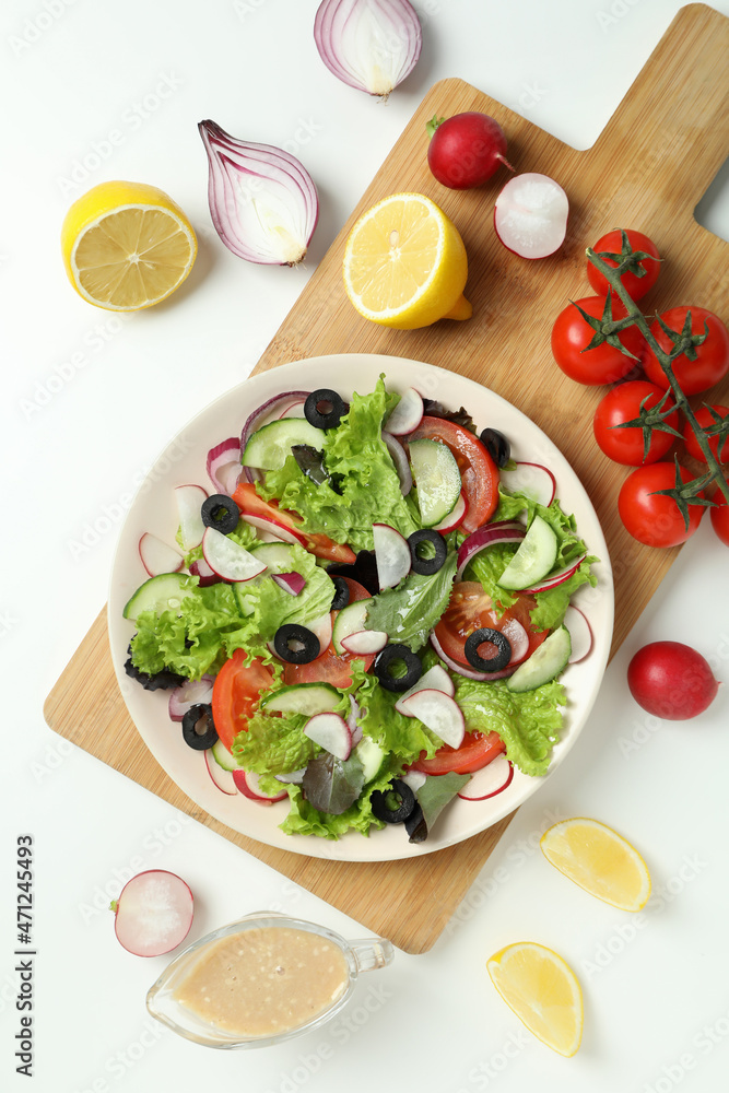 Concept of tasty food with vegetable salad with tahini sauce on white background Concept of tasty food with vegetable salad with tahini sauce on white background