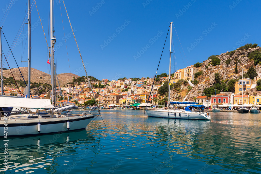 Sailing boats mooring in port of Gialos, Symi island, Greece