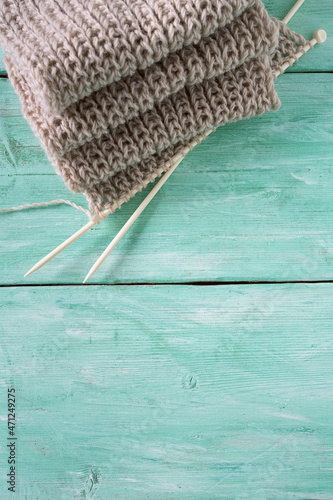 knitted scarf on turquoise wooden background photo