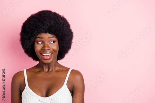 Photo portrait curly girl in white top smiling looking copyspace isolated pastel pink color background